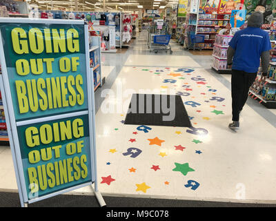 King of Prussia, PA, USA. 23rd March, 2018. A Toys R Us worker walks by a going out of business sign as Toys 'R' US store closing begins Credit: Don Mennig/Alamy Live News Stock Photo