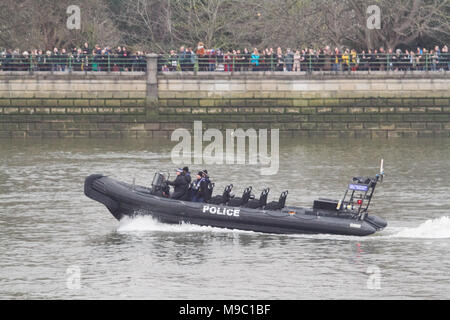 London UK. 24th March 2018. A police dinghy patrols the River Thames as Thousands  of spectators line Putney embankment   to watch the start of the University mens boat race Credit: amer ghazzal/Alamy Live News Stock Photo