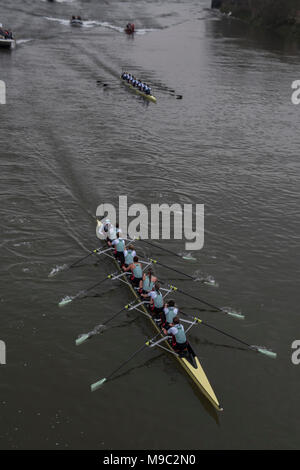 London, UK. 24th march, 2018. The womens senior crews pass Hammersmith Bridge with Cambridge in the lead - The Oxford v Cambridge Boat Race takes place on the Thames. This is the 164th Boat Race, with both crews tackling The Championship Course, which stretches 4.2 miles from Putney to Mortlake. Credit: Guy Bell/Alamy Live News