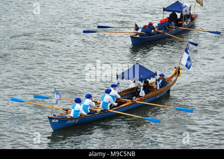 London, UK, 24 Mar 2018. Traditional craft rowing over The Cancer Research UK Boat Race course before the start of the four Boat Races. Credit: Michael Preston/Alamy Live News Stock Photo