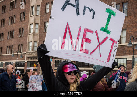 Reno, Nevada, USA. 24th Mar, 2018. On Saturday, March 24, 2018, a young participant moves along S. Virginia St. during the March for Our Lives event in Reno, Nevada, holding a sign reading, ''Am I Next?''.More than hundreds of similar events at cities around the country that have sprouted off a national march in Washington, DC, organized by student survivors of the February 14 shooting at Marjory Stoneman Douglas High School in Florida where 17 were killed. Credit: Tracy Barbutes/ZUMA Wire/Alamy Live News Stock Photo