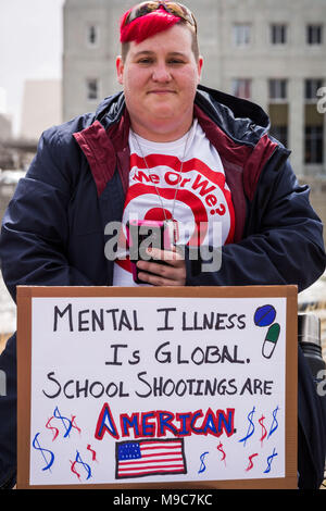 Reno, Nevada, USA. 24th Mar, 2018. A an unidentified participant listens to speakers at the Reno City Plaza during the March for Our Lives event in Reno, Nevada, on Saturday, March 24, 2018.The event is one of hundreds of similar such events at cities around the country that have sprouted off a national march in Washington, DC, organized by student survivors of the February 14 shooting at Marjory Stoneman Douglas High School in Florida where 17 were killed. Credit: Tracy Barbutes/ZUMA Wire/Alamy Live News Stock Photo