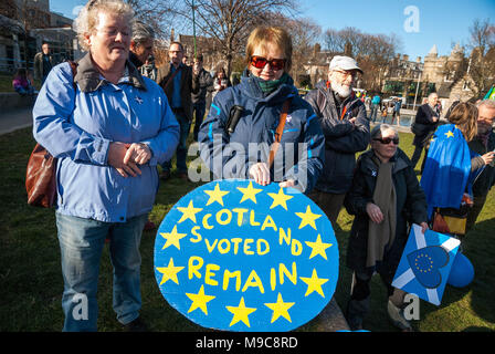 Edinburgh, Lothian, UK. 24th Mar, 2018. A protester poses for photographers camera while showing a sign that reads ''SCOTLAND VOTED REMAIN'' post protest.Organized by European Movement in Scotland as well as the Young European Movement from Edinburgh, protesters took the street to mark the 1st anniversary of the Article 50 and call for a ''˜democracy on Brexit' in Edinburgh streets. Credit: Stewart Kirby/SOPA Images/ZUMA Wire/Alamy Live News Stock Photo