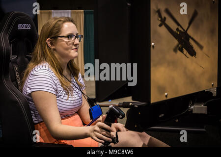 Reno, Nevada, USA. 24th Mar, 2018. ABIGAIL JARVE maneuvers a flight simulator in the U.S. Marines exhibitor booth during the 29th Annual Women in Aviation International (WAI) Conference at the Reno-Sparks Convention Center in Reno, Nevada, on Saturday, March 24, 2018. Jarve, a flight instructor at the University of North Dakota, is attending her first WAI conference. Credit: Tracy Barbutes/ZUMA Wire/Alamy Live News Stock Photo