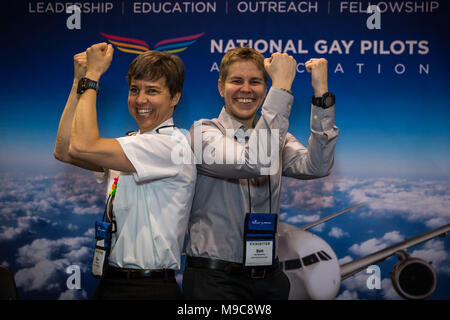 Reno, Nevada, USA. 24th Mar, 2018. GINA MARTYN (l) and BETH BLANKENSHIP (r) flex their muscles during the 29th Annual Women in Aviation International (WAI) Conference at the Reno-Sparks Convention Center in Reno, Nevada, on Saturday, March 24, 2018. Martyn, from Boulder, Colorado, and Blankenship, from Queens, New York, are representives in the National Gay Pilots Association exhibitor booth. Saturday is set aside as the Girls in Aviation Day at the conference. Credit: Tracy Barbutes/ZUMA Wire/Alamy Live News Stock Photo