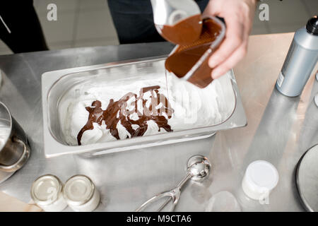 Pouring chocolate on the ice cream Stock Photo