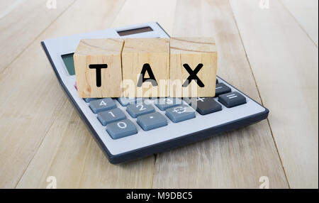 Tax on Wood Blocks on Top of Calculator Stock Photo