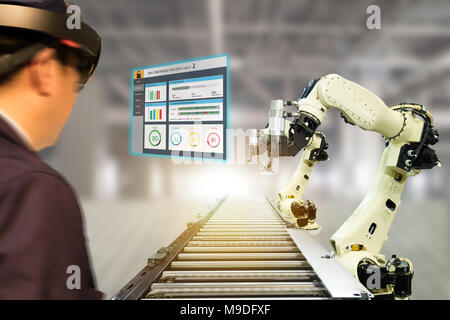 iot industry 4.0 concept,industrial engineer(blurred) using smart glasses with augmented mixed with virtual reality technology to monitoring machine i Stock Photo