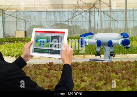 iot smart industry robot 4.0 agriculture concept,industrial agronomist,farmer using software Artificial intelligence technology in tablet to monitorin Stock Photo