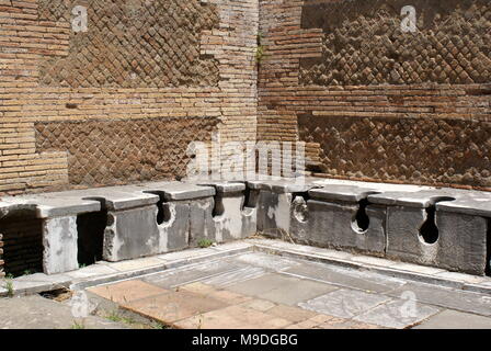 Public latrines, Ostia Antica archaeological site, the location of the harbour city of ancient Rome, Rome Italy Stock Photo