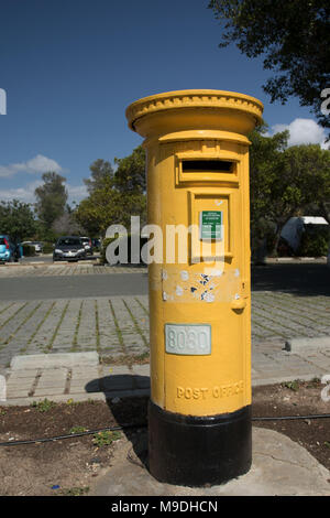 Old style yellow postbox , without the bugle, in paphos, cyprus Stock Photo
