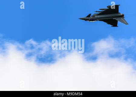 farnborough Airshow 2016: a Eurofighter Typhoon flies inverted above some clouds Stock Photo