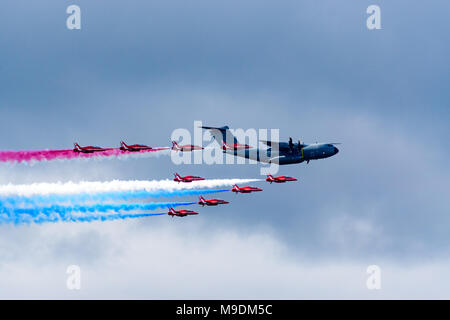 Farnborough Airshow 2016: the Red Arrows formate on an Airbus A400M military transport for a fly past Stock Photo