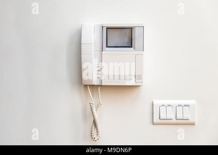 Closeup day view intercom unit on white wall in flat Stock Photo