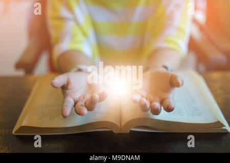 Close up of a handsome woman worshiping his beloved god. Worship and respect for the gods he loves and the struggle for God. The hands and the cross a Stock Photo