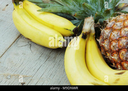 Banana and pineapple on the old wooden. Stock Photo