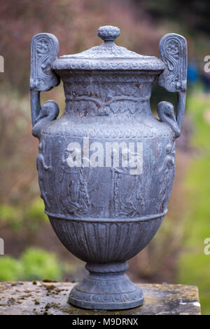 stone Greek urn isolated in English country garden with blurred background Stock Photo