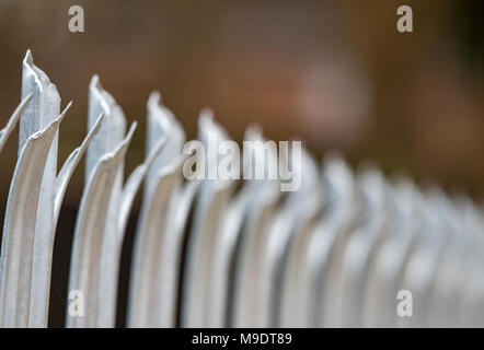 razor sharp palisade security fencing surrounding private property. security measures and fencing for protection and surrounding secure and securing. Stock Photo
