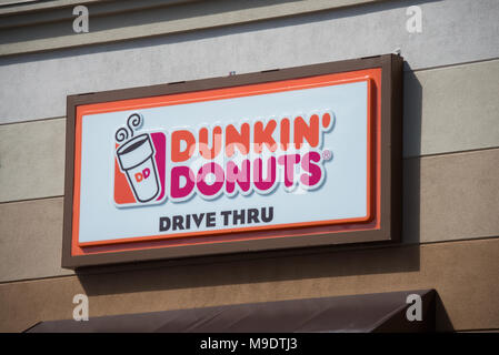 A Dunkin' Donuts drive thru sign on the side of a restaurant building in Mayfield, NY USA Stock Photo