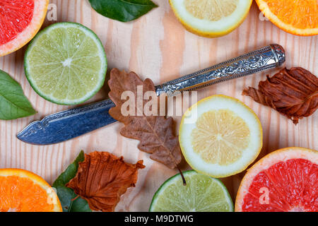 Cut oranges, lemons, lime and grapefruit placed on wood. Citrus. Stock Photo