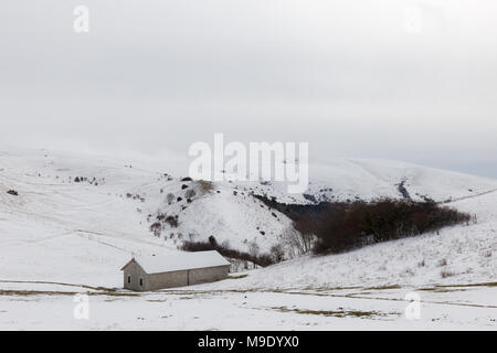 A small mountain retreat covered by snow on Mt. Subasio (Umbria, Italy) during winter season Stock Photo