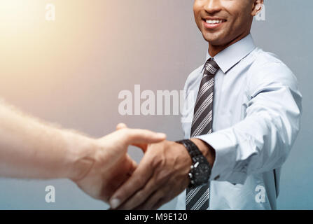 Business concept - Close-up of two confident business people shaking hands during a meeting.  Stock Photo