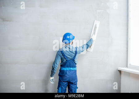 Plasterer working indoors Stock Photo
