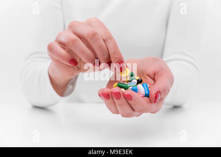 Medicines in the form of tablets and in female hands. Stock Photo