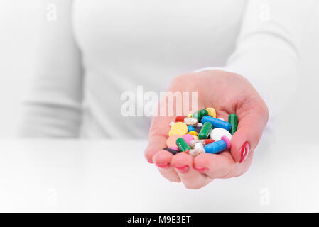 Medicines in the form of tablets and in female hands. Stock Photo