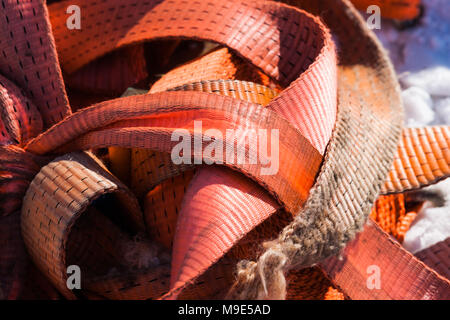 Bunch of orange plastic construction tape in snow. Decorative pattern Stock Photo
