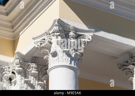 Corinthian capital of a vintage column, which supports a roof eave of a old stylish house Stock Photo