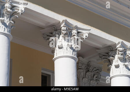 Corinthian capital of a vintage column, which supports a roof eave of a old stylish house Stock Photo