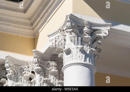 Corinthian capital of a vintage column, which supports a roof eave of a old stylish house Stock Photo