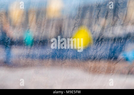 Blurred reflections in a window glass curtained with some plastic cloth Stock Photo