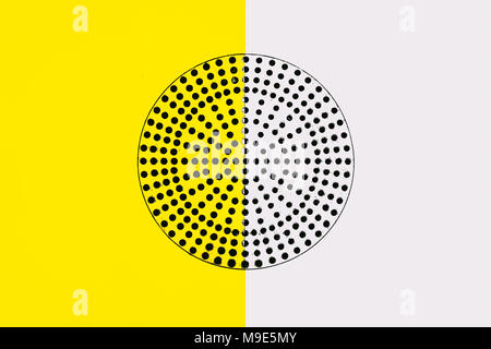 Metal surface painted in yellow and white. Black circle with a lot of small perforated holes in the middle. Industrial pattern Stock Photo