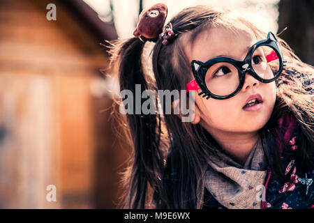 Cute little mixed race girl wearing funny glasses Stock Photo
