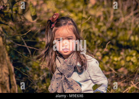 Cute little mixed race girl in the woods Stock Photo
