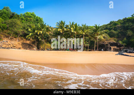 Paradise beach in Gokarna, India. Beautiful deserted landscape with clean sand and wave. View from the sea to the shore. Stock Photo