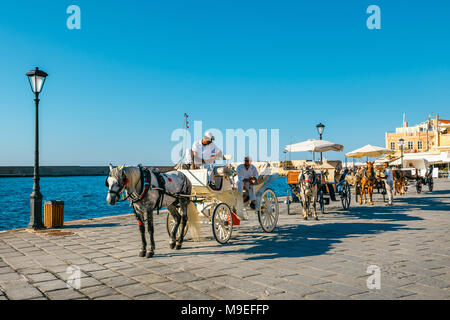Chania, Crete - 23 Maj, 2016: Horse carriage for transporting tourists in old port of Chania on Crete, Greece. Chania is the second largest city of Cr Stock Photo