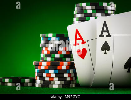 Stack of chips and two aces on the table on the green baize - poker game concept Stock Photo