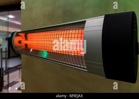 heater electric on the cold floor winter device. Heating the room in the cold winter. Warm bright halogen heater. Stock Photo