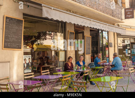 People sitting outside in a café-bar in the old centre of Tarascon, France Stock Photo