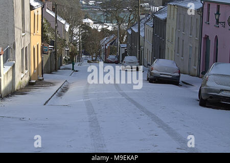 road and sidewalk covered in a fresh fall of snow. castletownshend, ireland Stock Photo