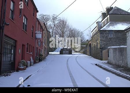 road and sidewalk covered in a fresh fall of snow. castletownshend, ireland Stock Photo