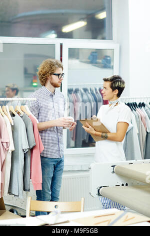 Two colleagues planning new collection together in workshop Stock Photo