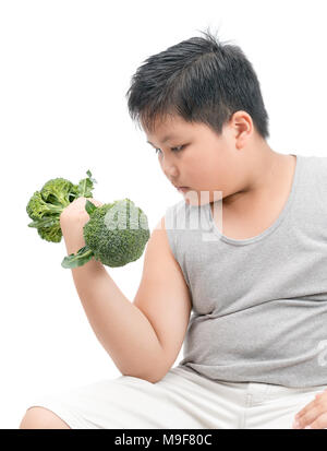 Obese fat boy holding a broccoli dumbbell isolated on white background, diet and exercise for good health concept Stock Photo