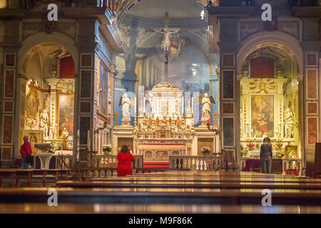 Visitors looking at the church's interior Chiesa di Ognissanti in Florence, Italy Stock Photo