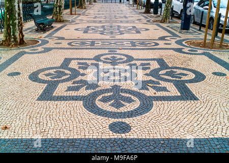 Vintage mosaic pavements in the historic city centre of Lisbon, Portugal. Stock Photo
