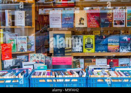 Primrose Hill Books, Old fashioned bookshop, bookstore book shop with crates of secondhand books outside stacked, London UK window book display learn Stock Photo