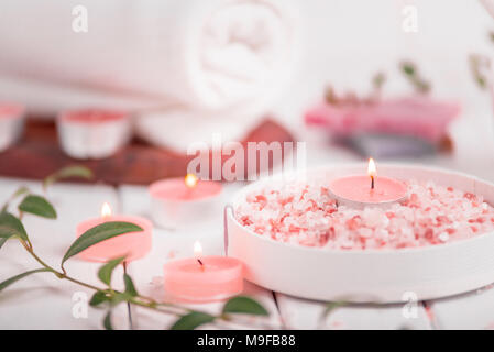 Handmade Salt Peach Scrub With Argan Oil. Himalayan Salt. Toiletries, Spa Set with candles and white towel. Stock Photo